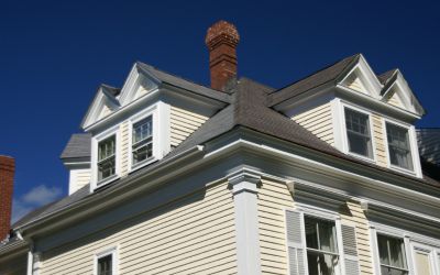 Close up exterior view of a residential house with siding installation by Rochester Roofing