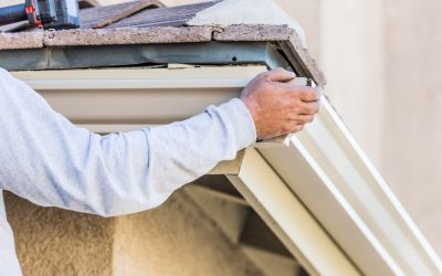 Close up view of a man doing gutter installation for Rochester Roofing company in Minnesota
